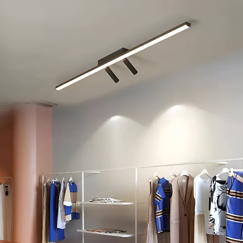 Acanthus Black LED Spotlight illuminating a cozy reading nook