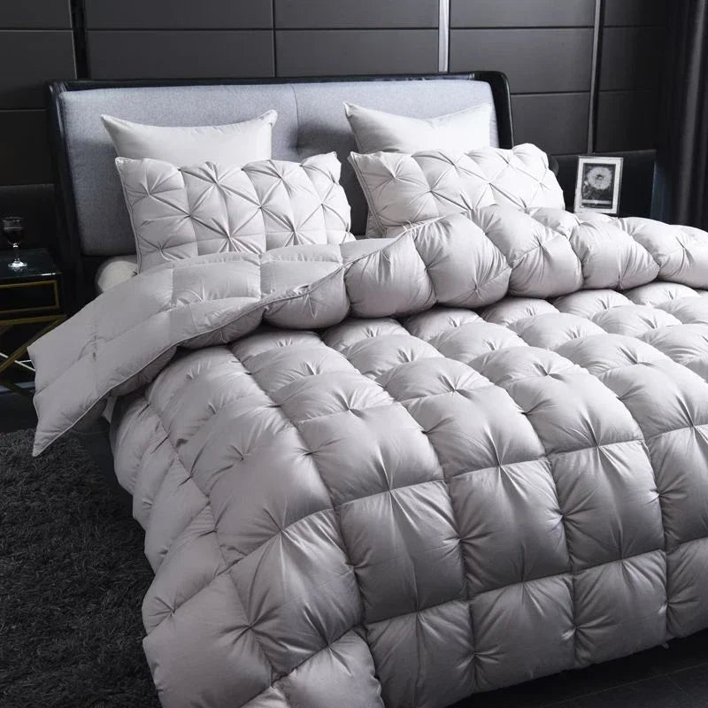 Alira lightweight goose down duvet in grey with pinch-pleat quilting in a dark bedroom