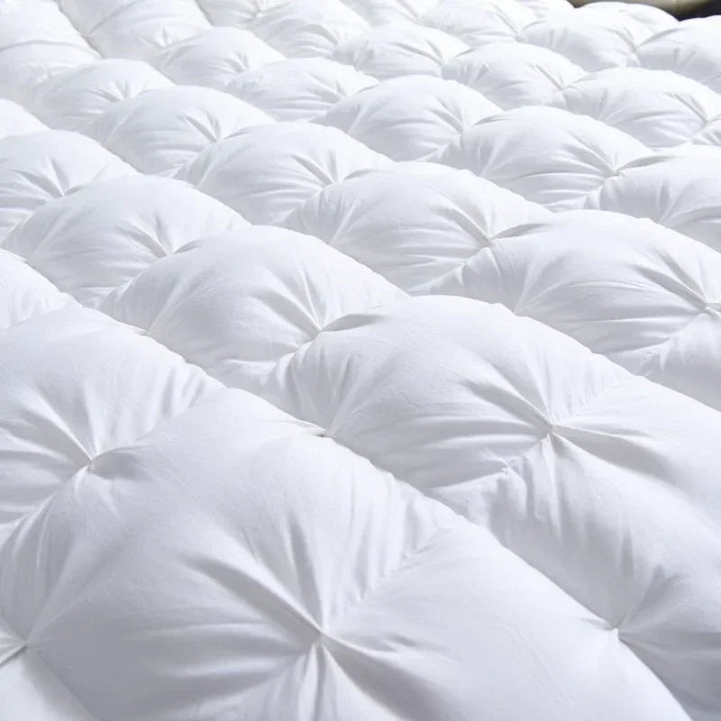 Close-up of the Alira goose down duvet in white showing its lofty pinch-pleat quilting