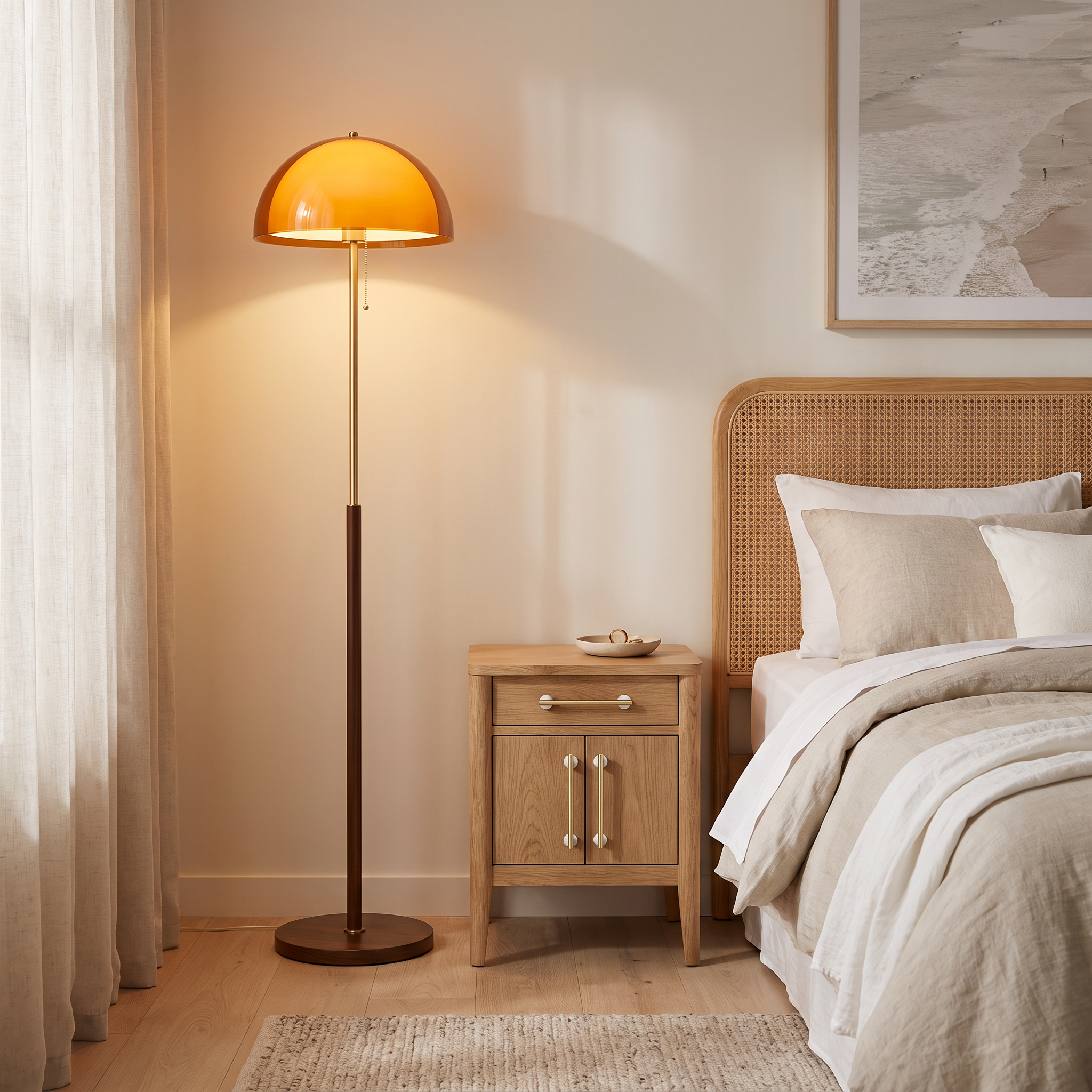 Caroline retro amber dome floor lamp standing in the corner of a coastal-Scandinavian bedroom beside a bedside table with brass and marble handles