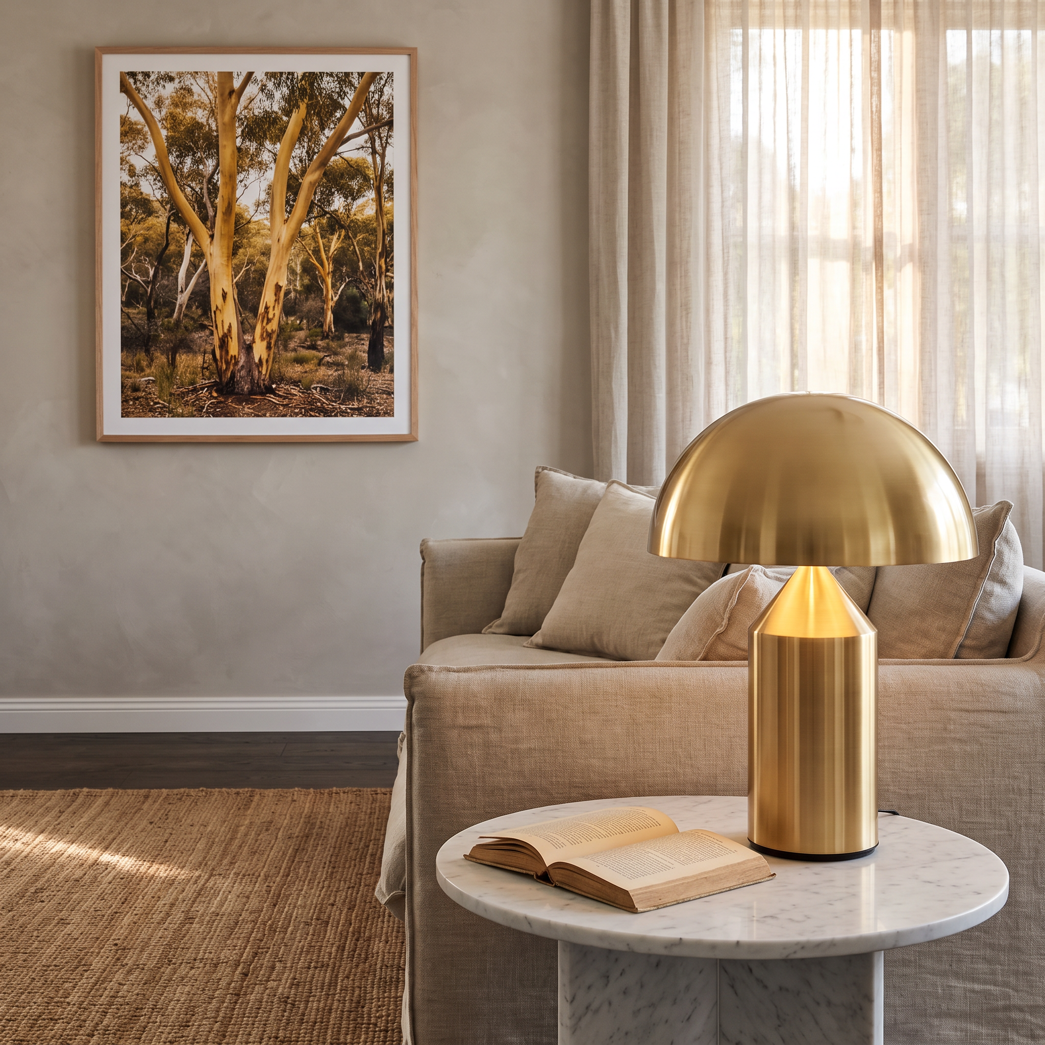 Moa gold cordless mushroom table lamp on a marble side table in a coastal-Scandinavian living room