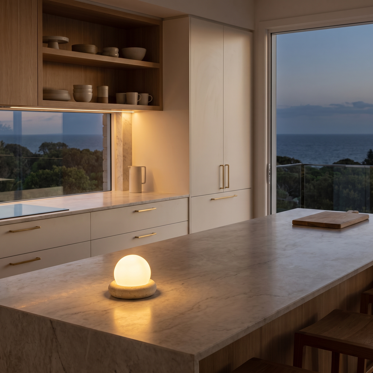 Amber travertine cordless LED lamp glowing on a marble kitchen island at dusk