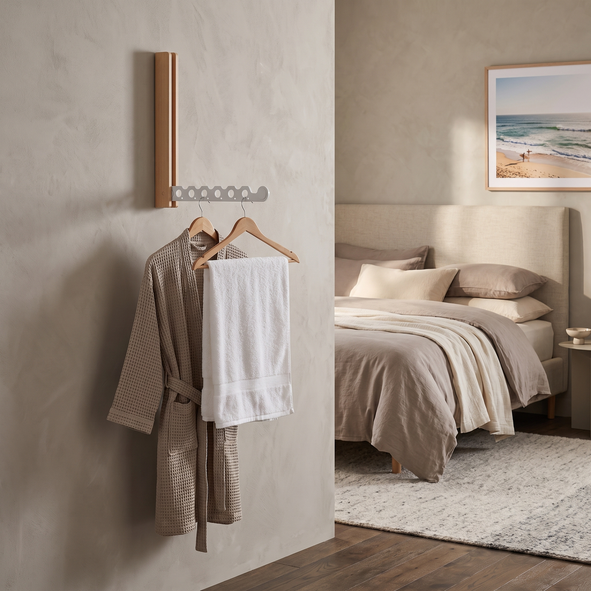 Arnie timber hanger rail in white with a robe and towel ready in a Scandinavian guest bedroom