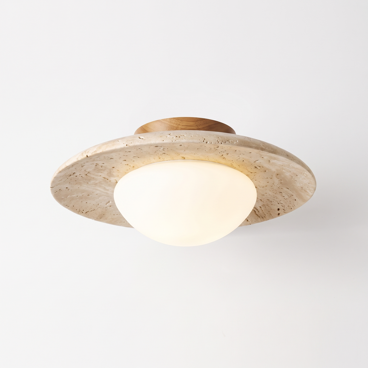 Bali travertine ceiling light on a plain white background showing the stone saucer shade and opal glass globe