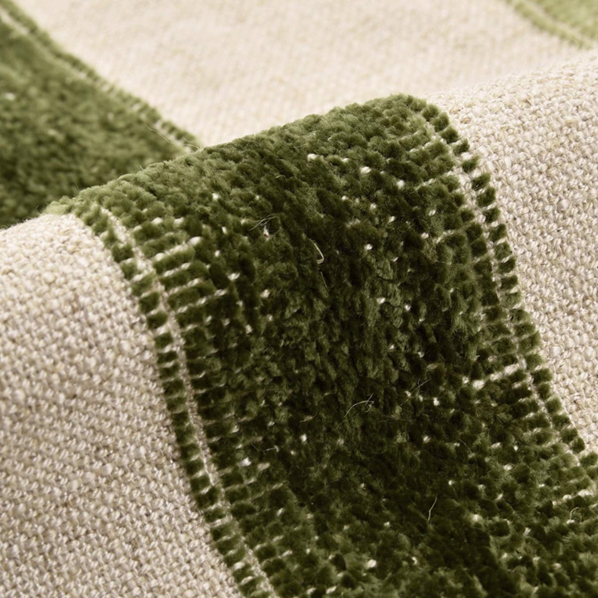 Macro view of the plush green velvet stripe woven into the Banks linen throw pillow