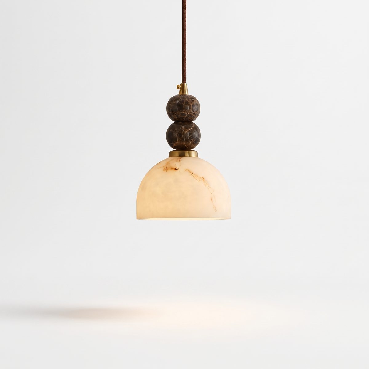 Banyjima Model E faux alabaster dome pendant with two marble spheres on a white background