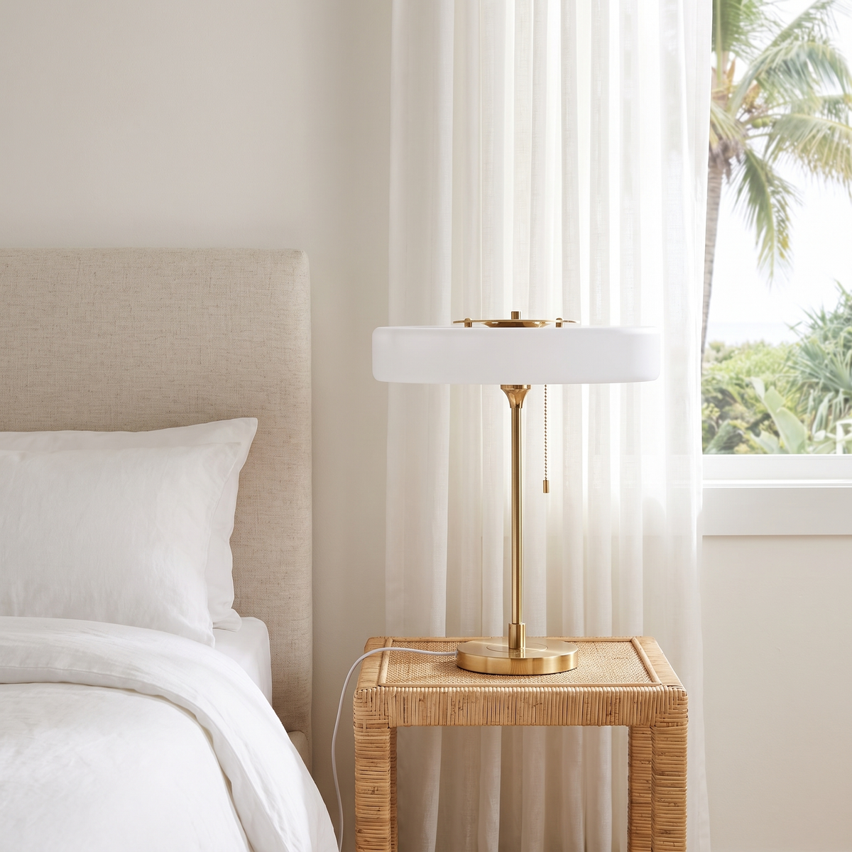 Baya minimalist table lamp in white on a rattan bedside table in a coastal bedroom