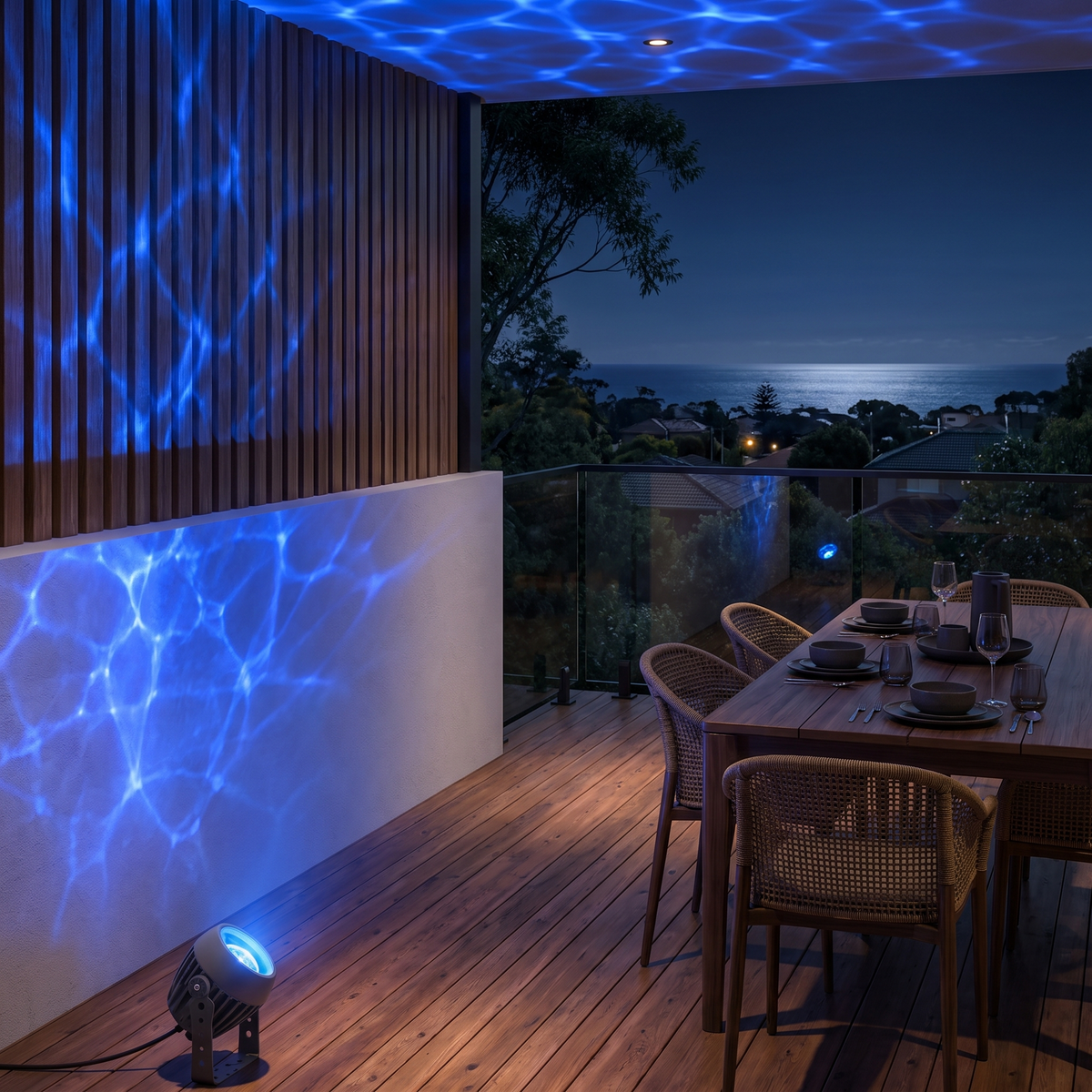 Beso water ripple outdoor spotlight washing a hillside entertaining deck in a blue ripple effect at night