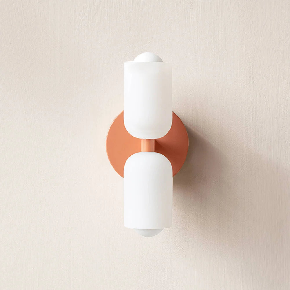 Boni up and down wall light with a pink wall plate and two white scalloped opal shades