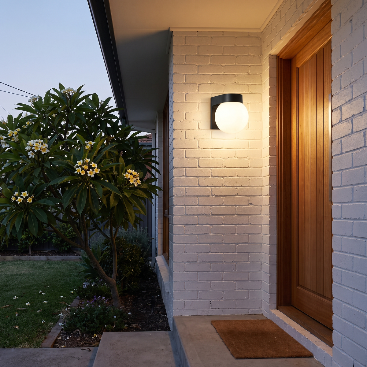 Brunswick outdoor wall sconce design A with opal globe beside a front door