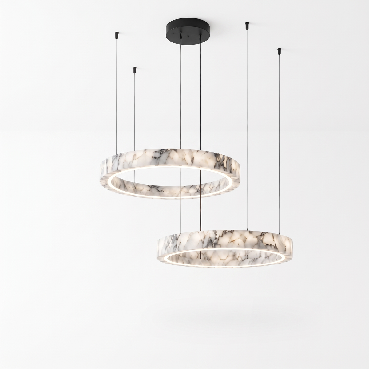 Byron two-ring marble chandelier with black canopy and cables on a plain white background