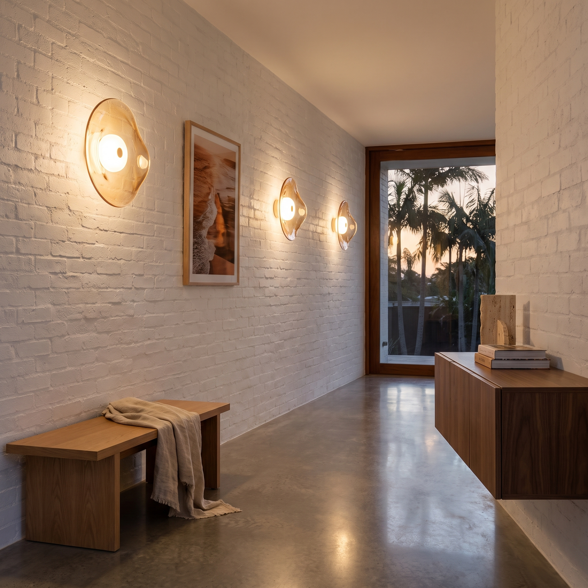 Cami glass wall sconce in amber glass along a bagged brick walkway in a Byron Bay beach house