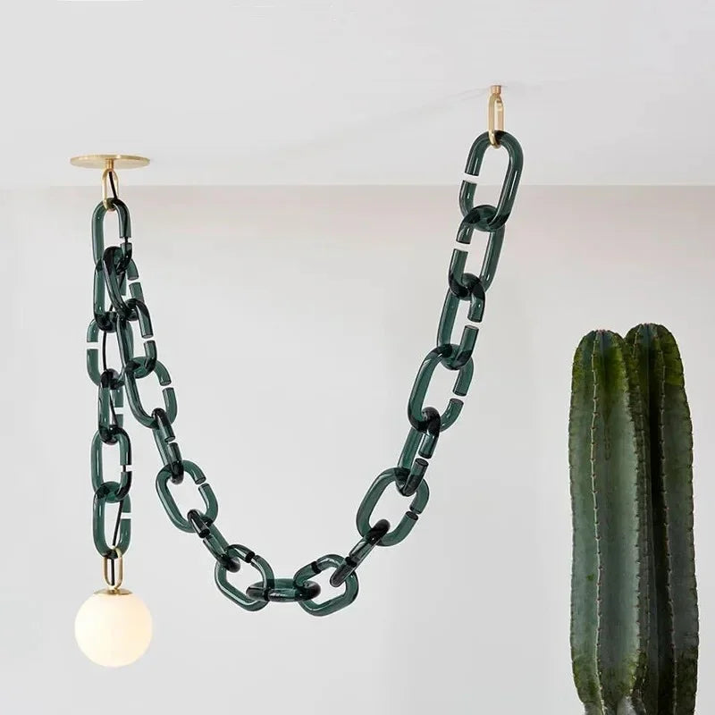 Clove dark green glass chain pendant light with brass ceiling canopy and white opal globe shade