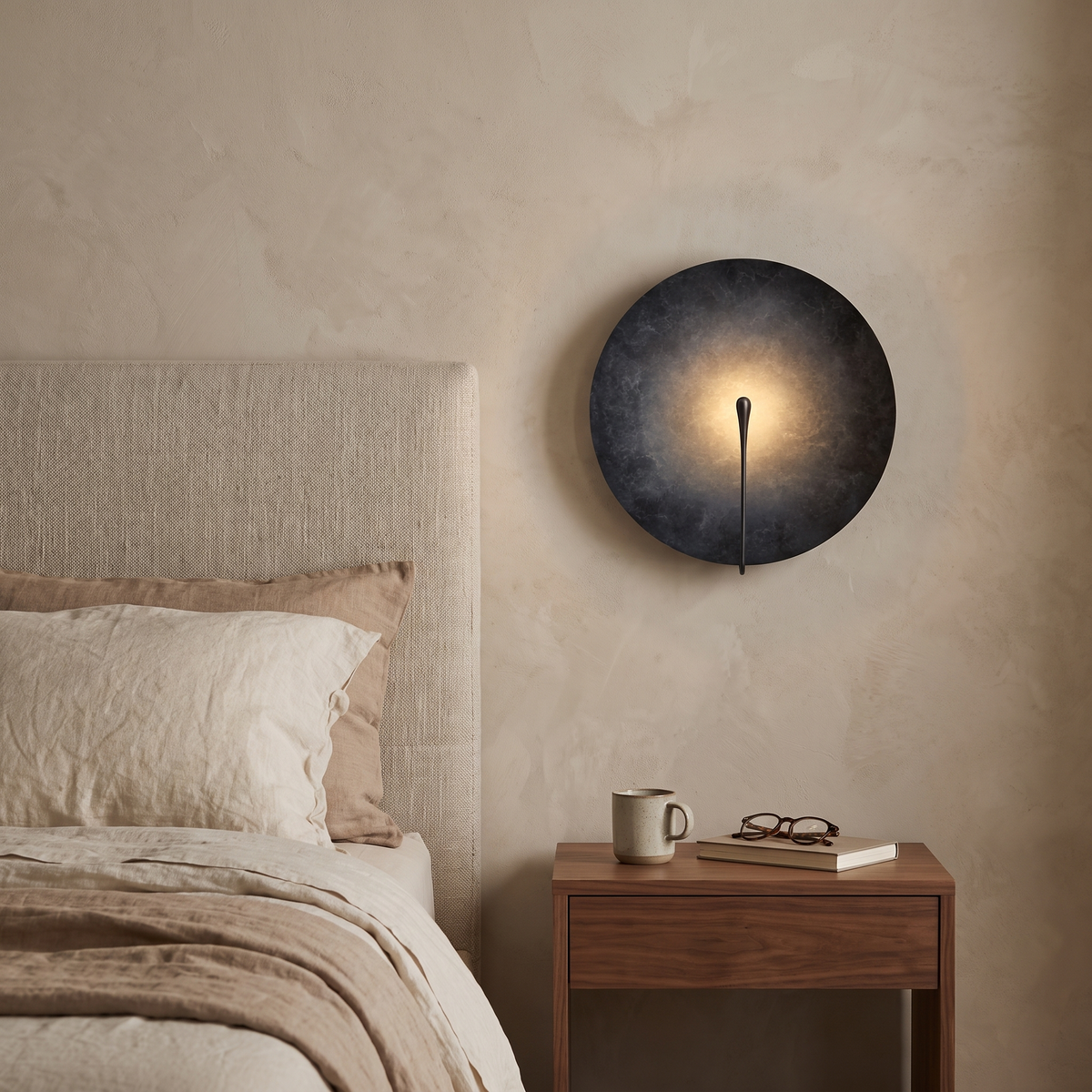 Clyde stainless steel round wall light in the dark finish in a bedroom