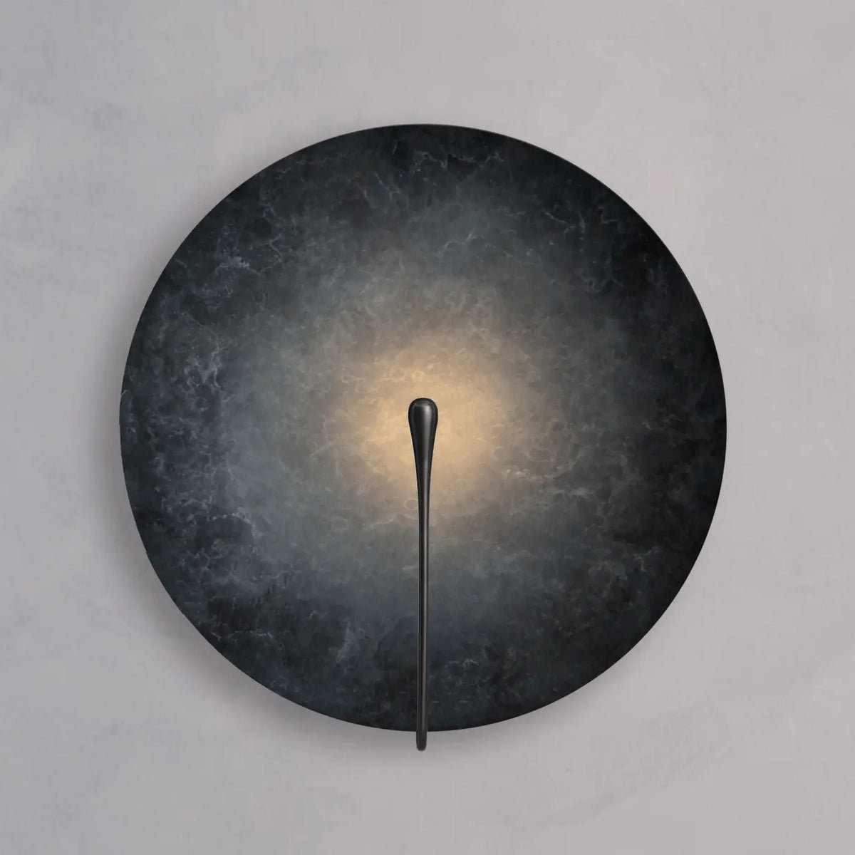 Clyde stainless steel round wall light in the dark finish with a warm glow at the centre