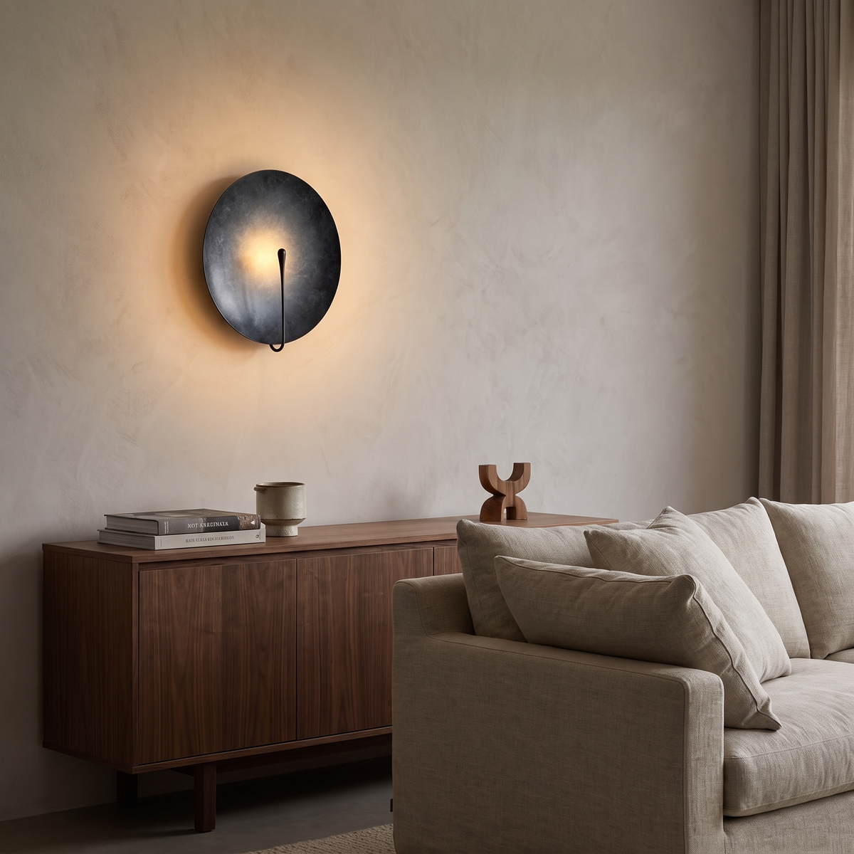Clyde stainless steel round wall light in the dark finish in a living room