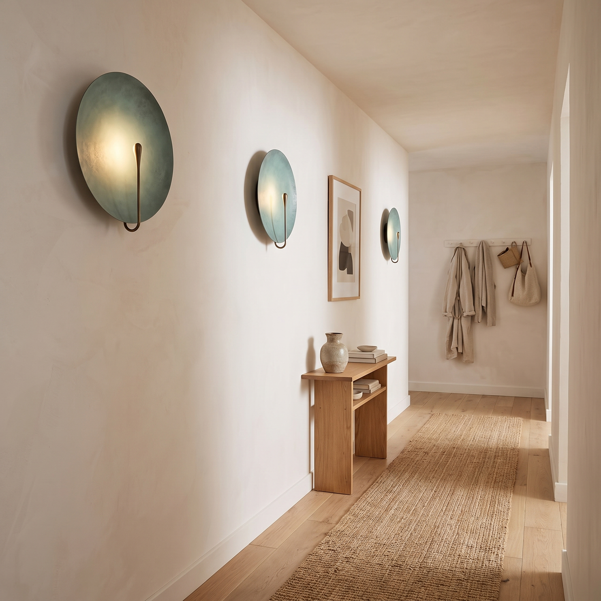 Clyde stainless steel round wall light in the light finish in a hallway