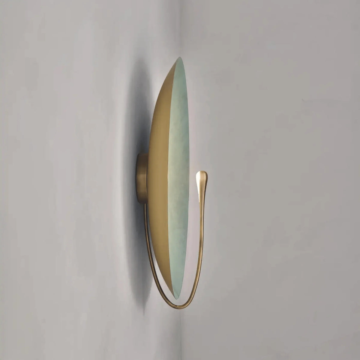 Clyde stainless steel round wall light side profile showing the slim curved lighting arm