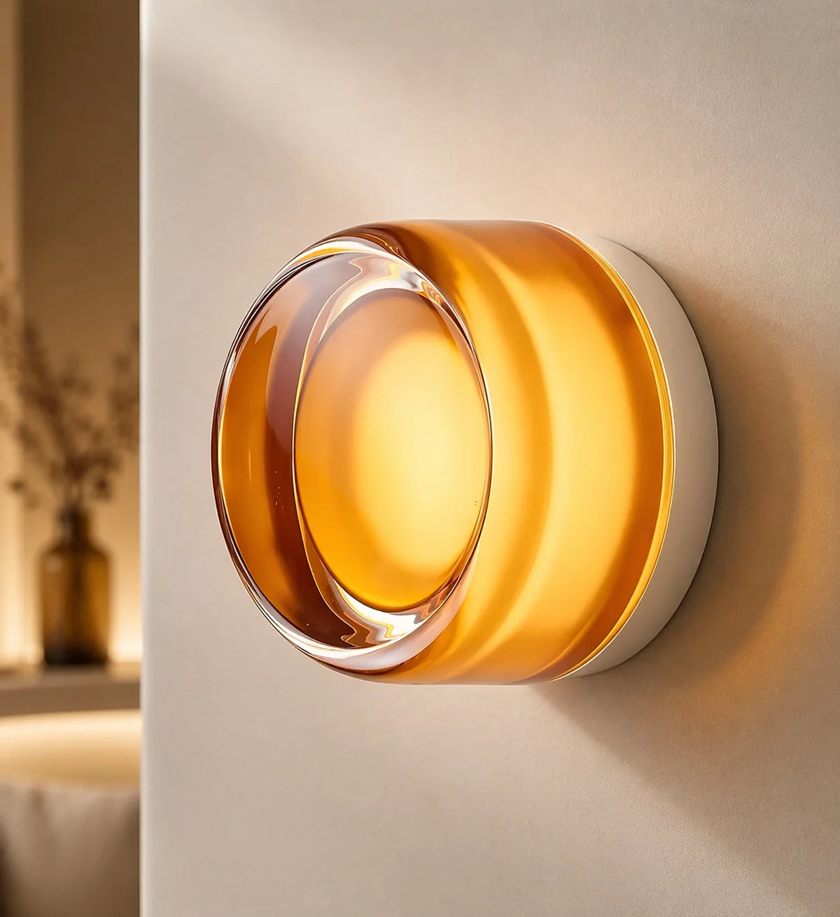 Comu golden amber Circle glass sensor wall light with clear outer ring glowing on a white wall