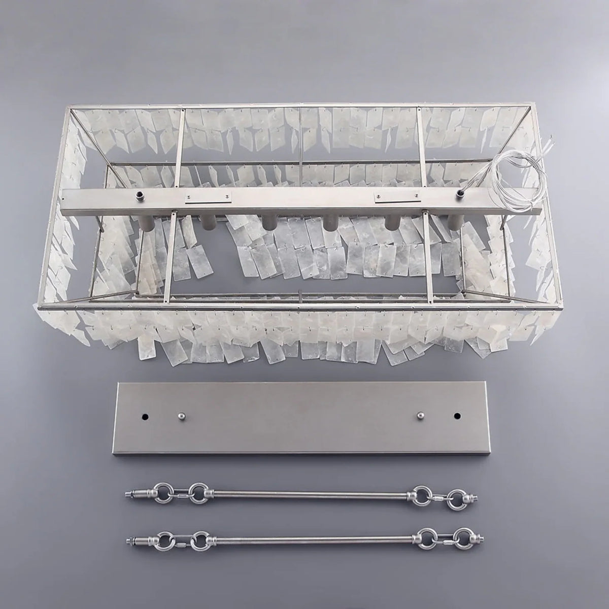 Coolum chandelier parts laid out: the shell frame, the ceiling mounting plate and two chrome rods