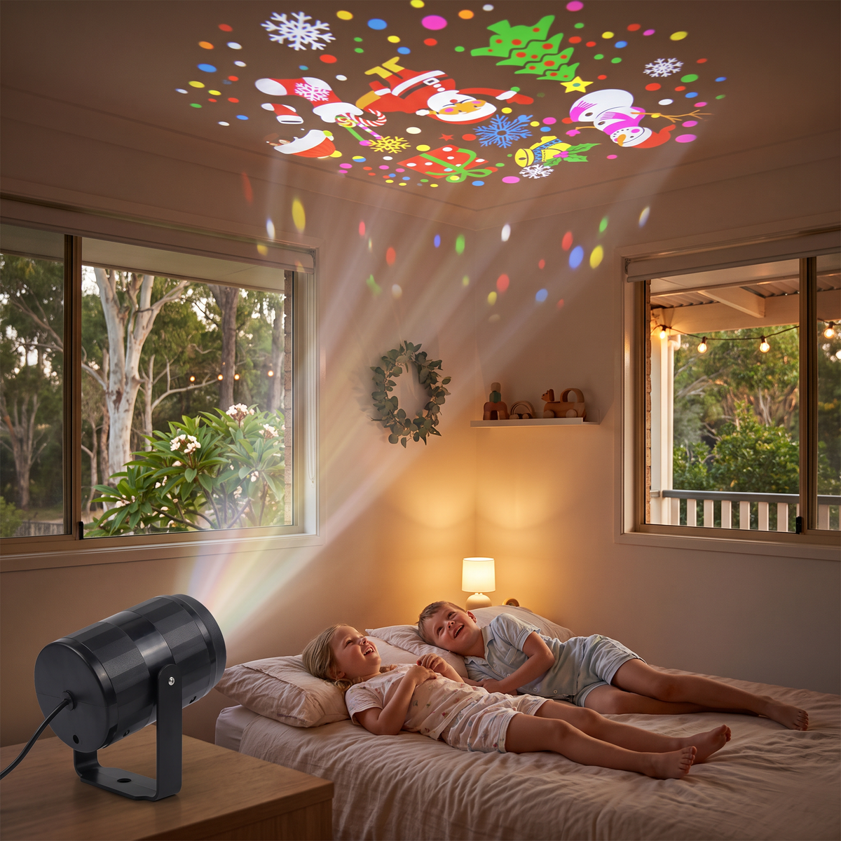 Daria LED Christmas projector lighting a kids bedroom ceiling with festive shapes on Christmas Eve