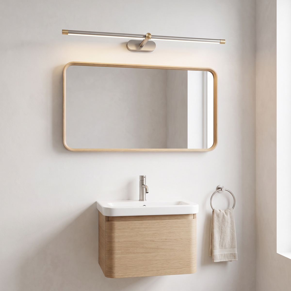 Debi brushed nickel and gold wall lamp above an oak-framed mirror in a Scandinavian powder room
