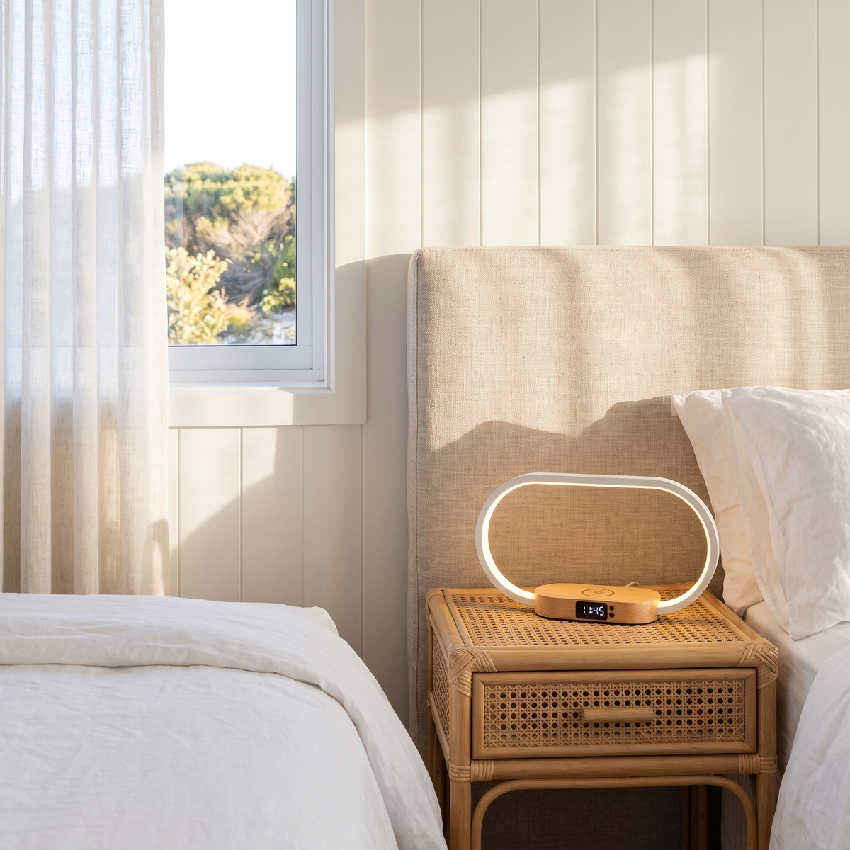 Dony rechargeable night light on a rattan bedside table in a coastal bedroom