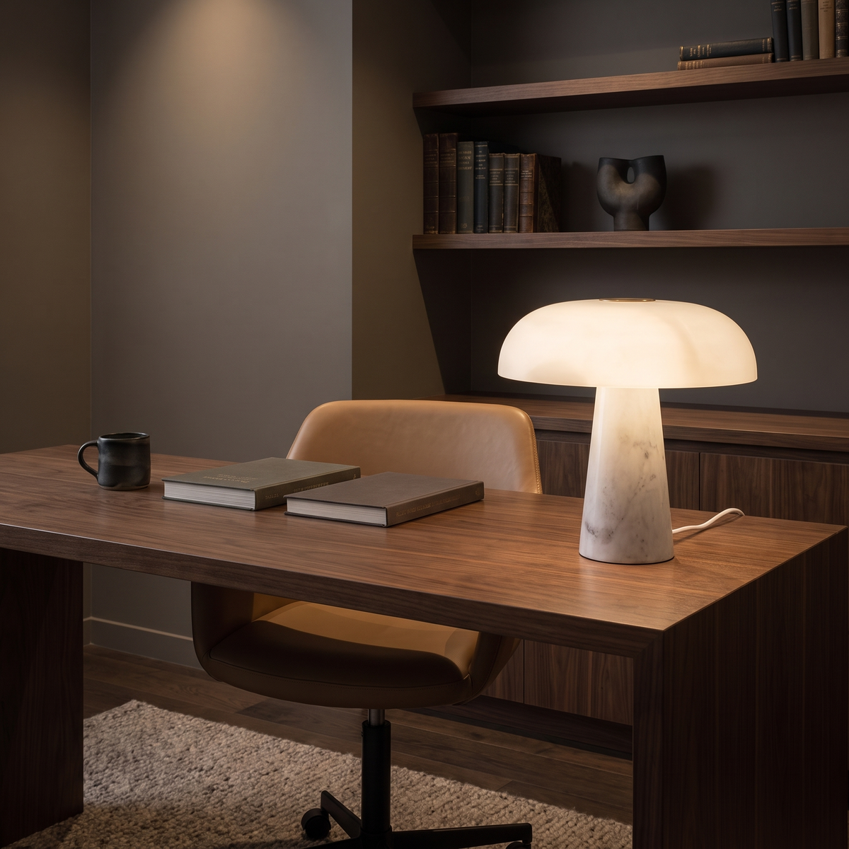 Dover Table Lamp with Marble Base lit on a dark walnut desk in a home study