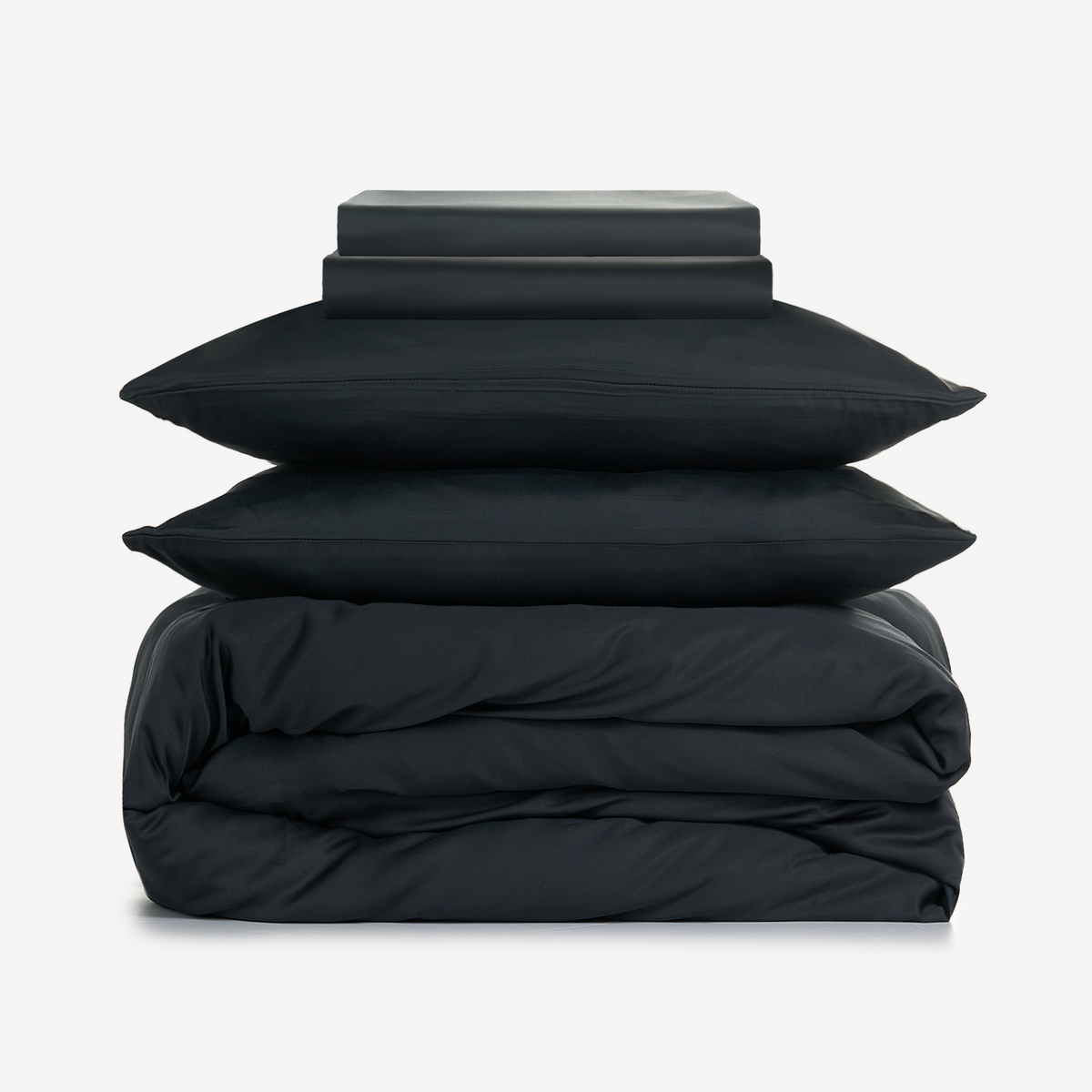 Eco Haven bamboo sheet set and duvet cover in black folded on a white background