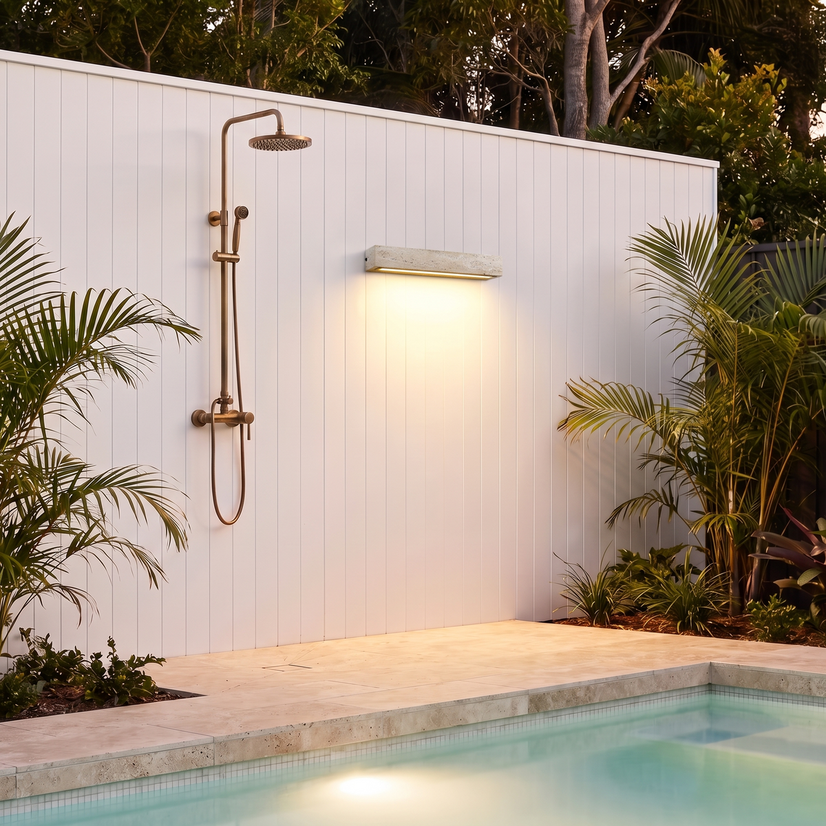 Large Elin travertine wall light beside an outdoor shower on a poolside cabana