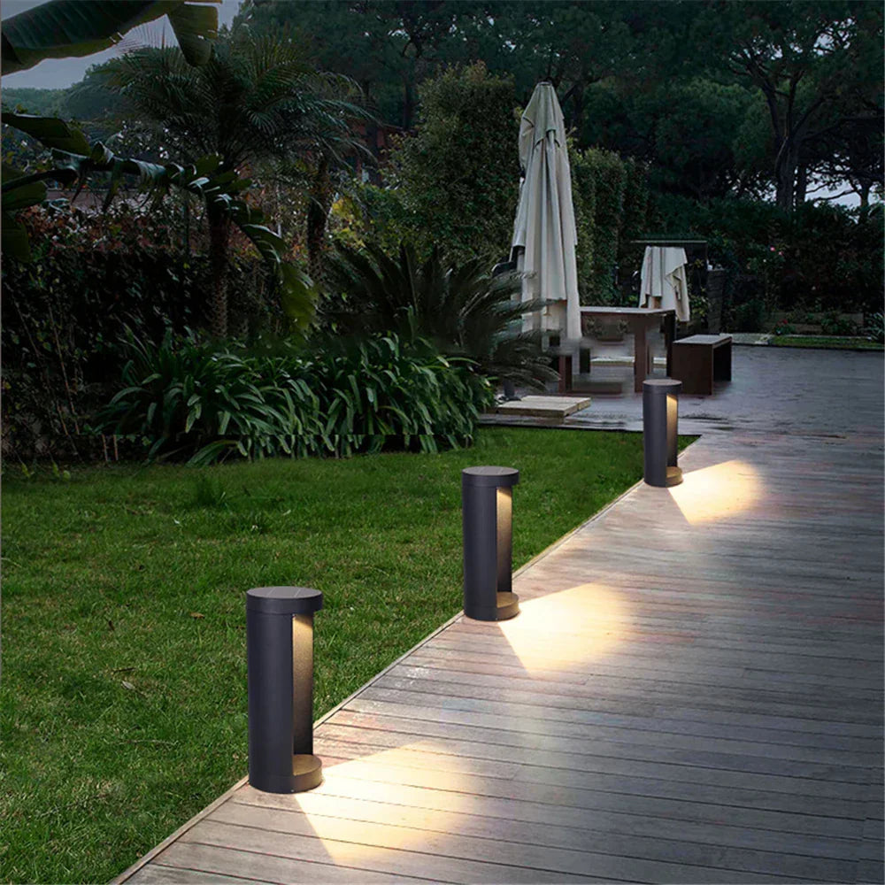 Elow LED Garden Bollard Light styled along a driveway