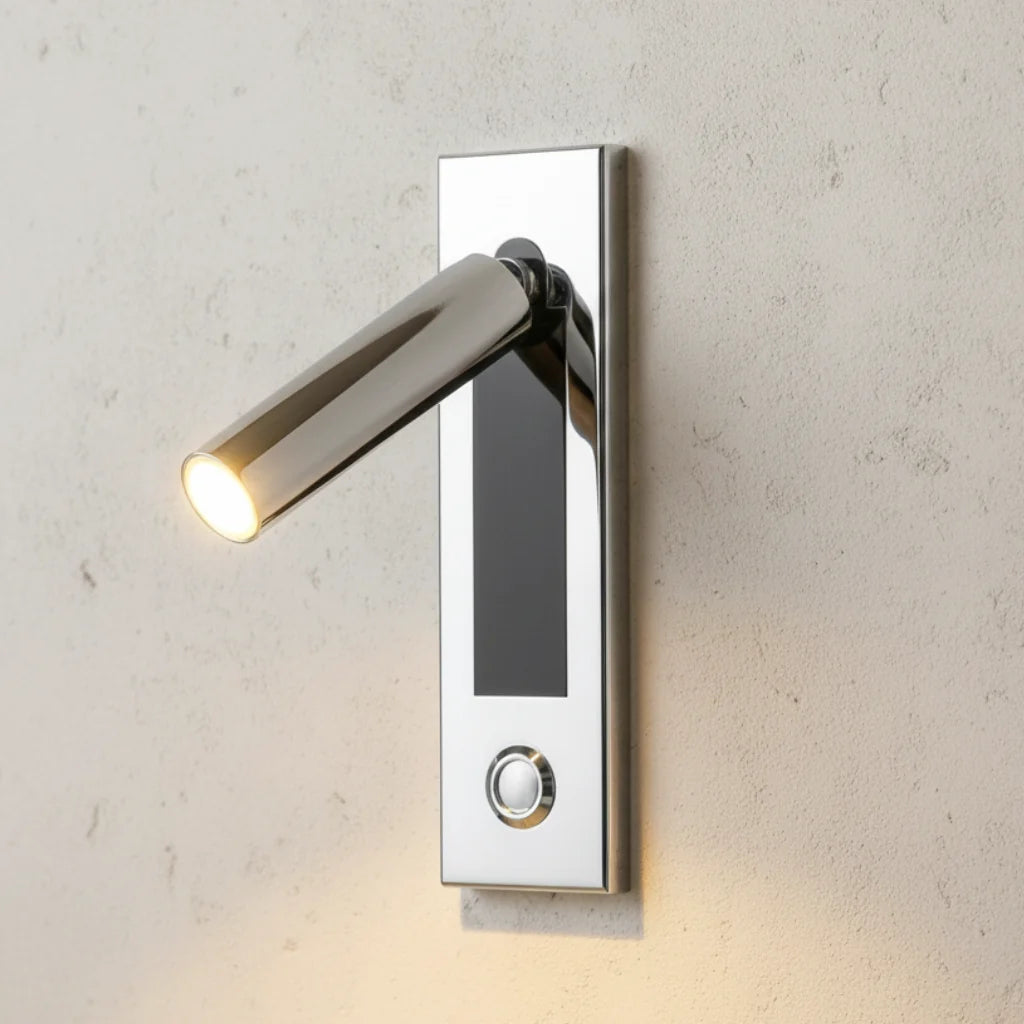 Espy LED reading wall light in cylinder chrome on a concrete wall