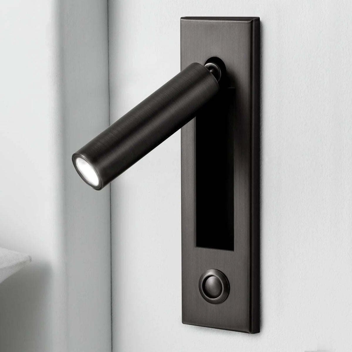 Espy LED reading wall light in cylinder matte black with the spotlight arm swung out