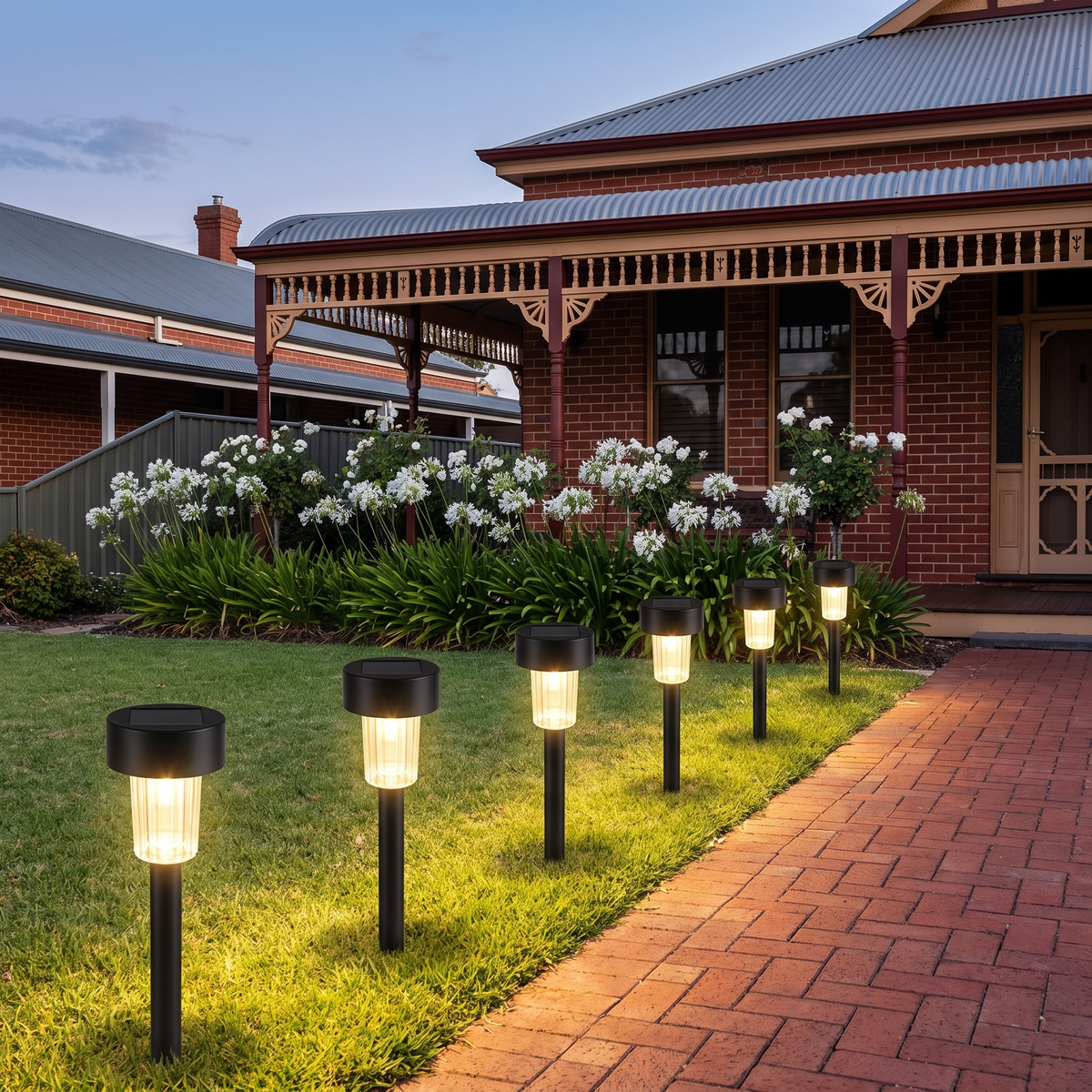 Fairlight solar path lights along a front lawn beside a brick path