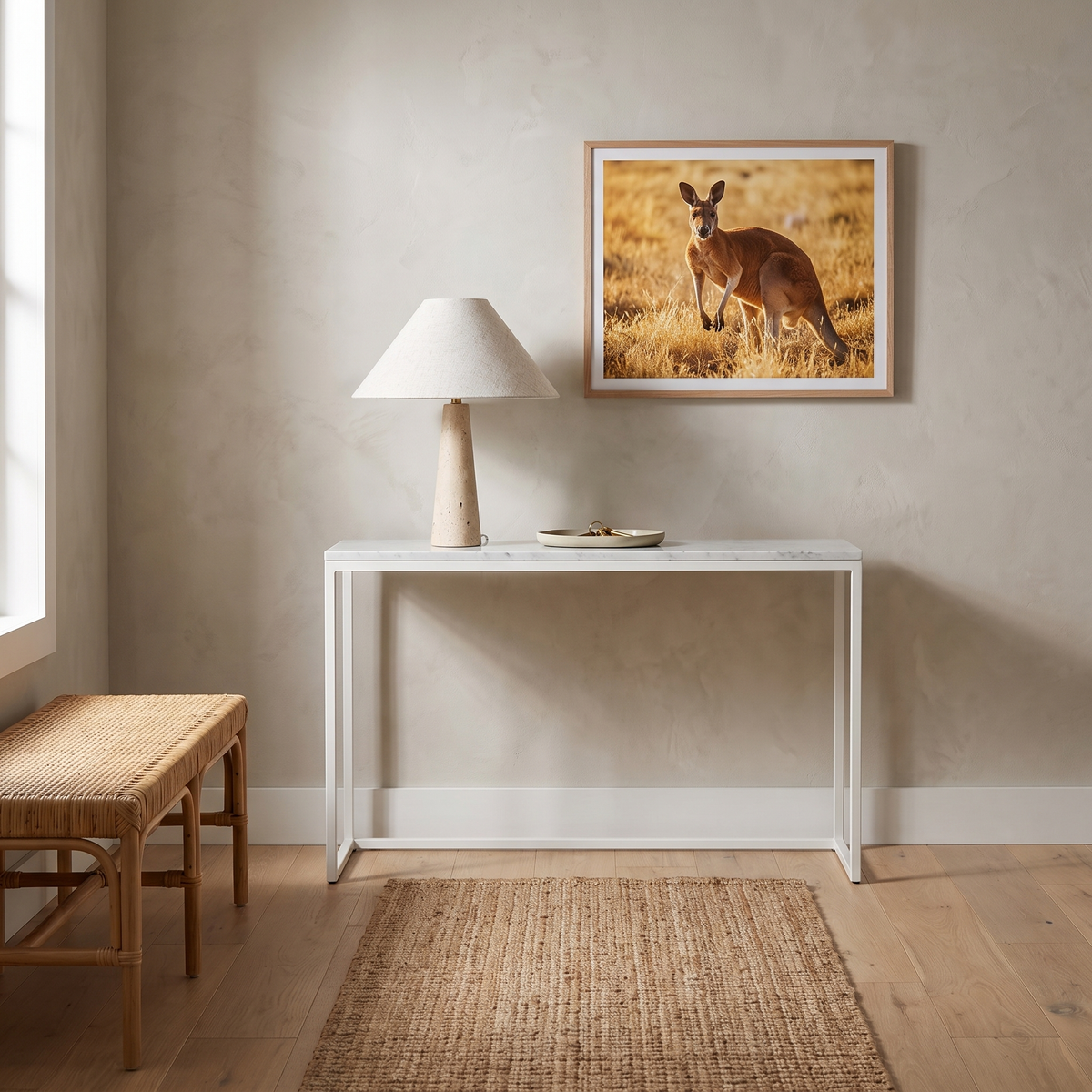 Fingal travertine table lamp on a marble console in a Scandinavian entry