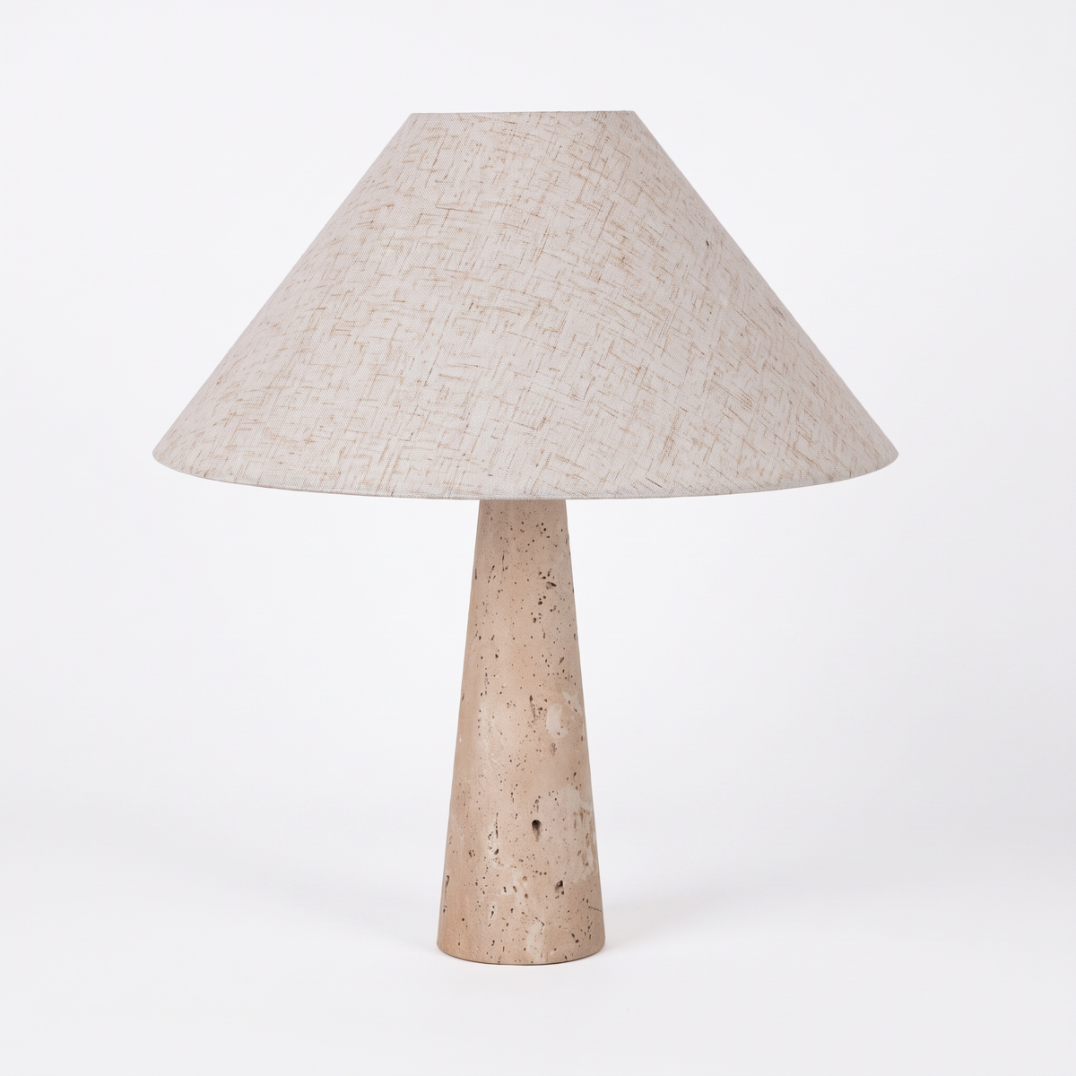 Fingal table lamp with travertine base and fabric shade on a white background
