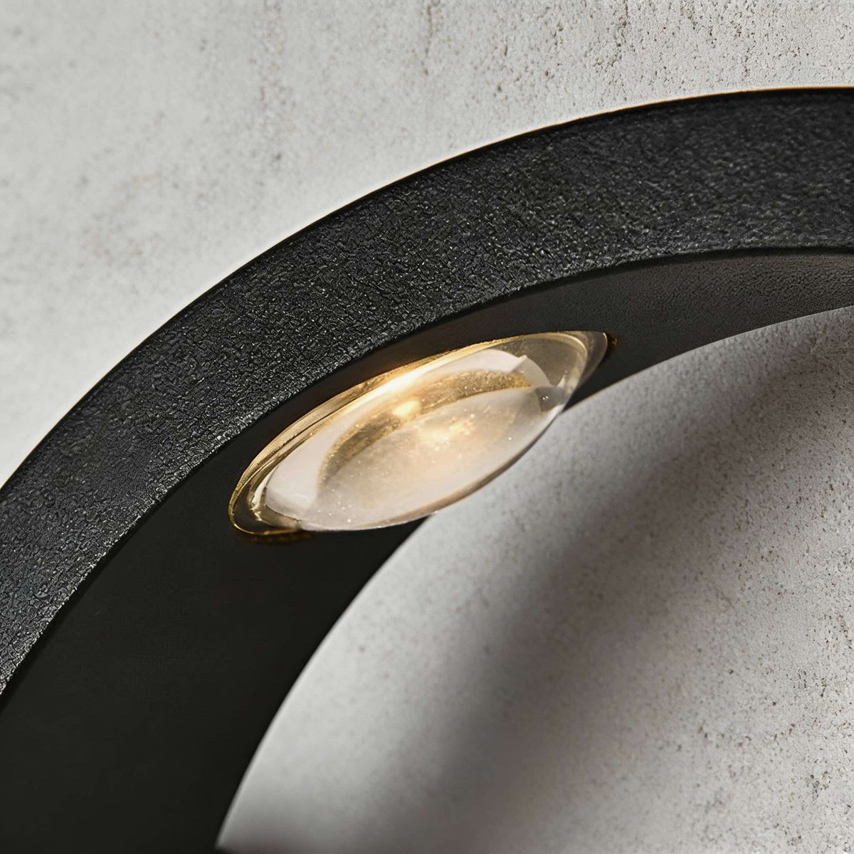 Close-up of the Fly outdoor wall light LED lens set into the curved black aluminium wing