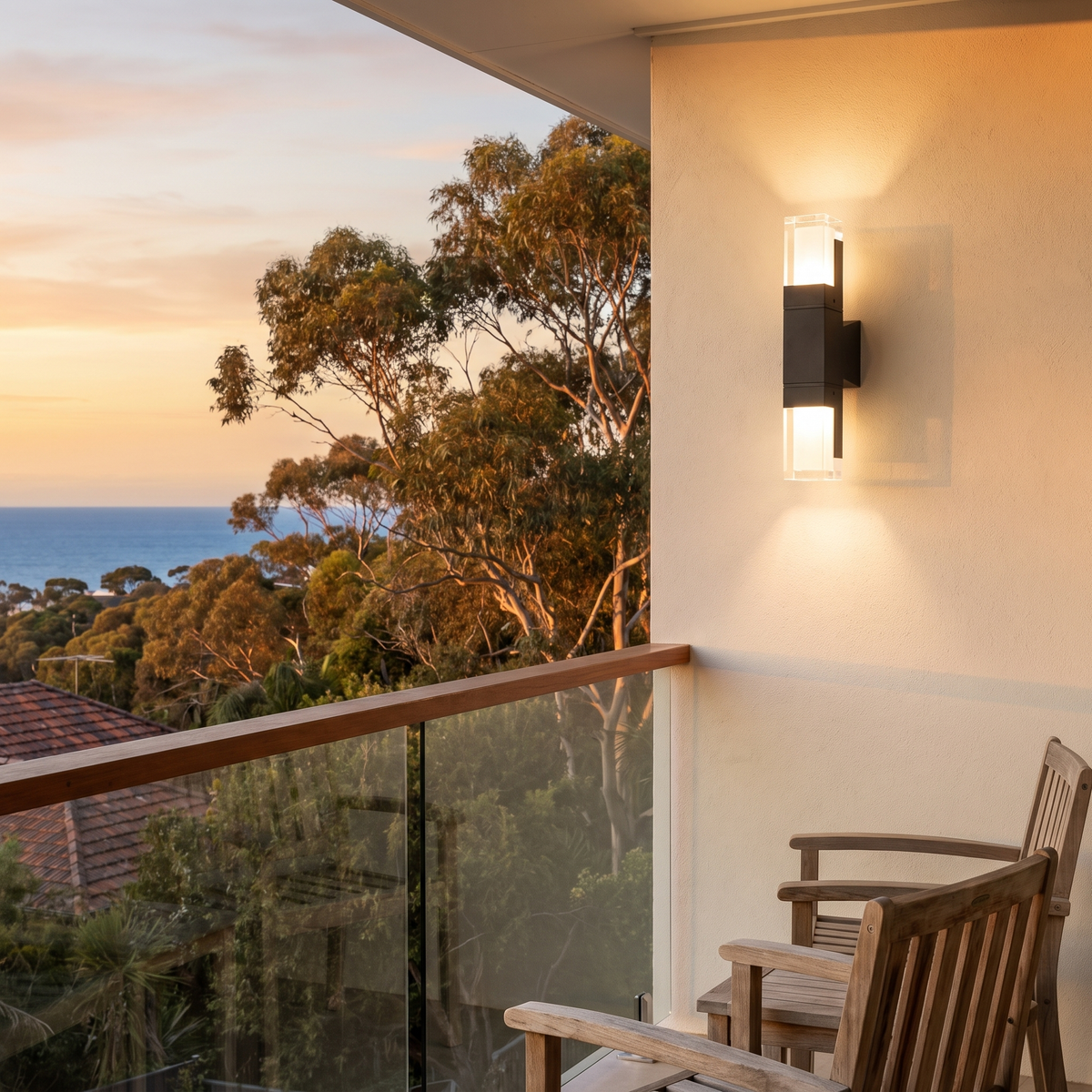 Freo Outdoor Wall Light, 14W up and down, on a hillside balcony with gums and ocean at golden hour