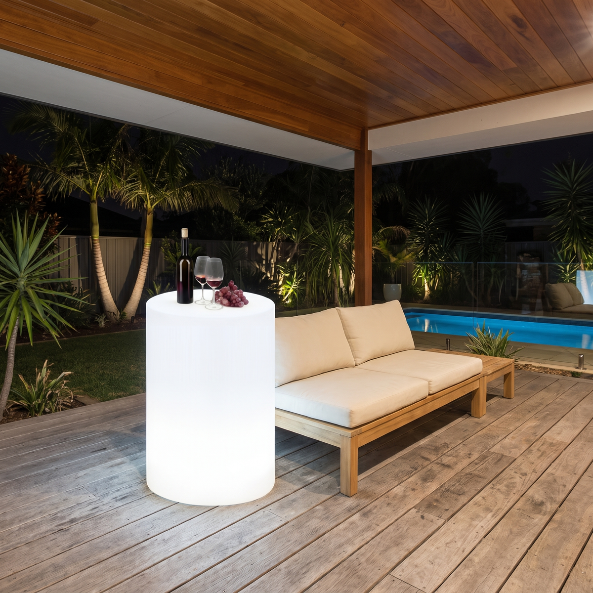 Geri large LED outdoor table glowing white as a bar leaner on an alfresco deck