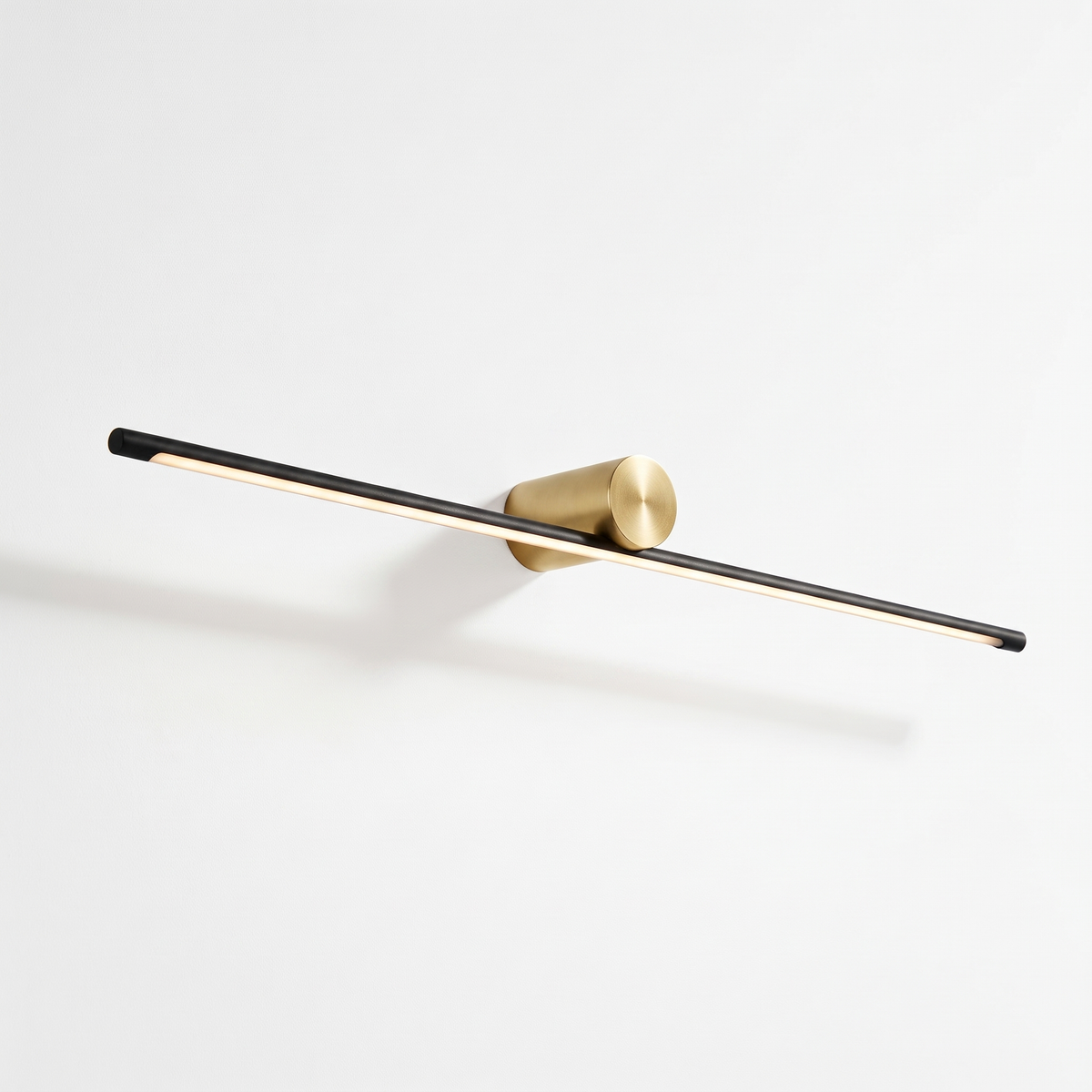 Hartog linear vanity light bar with black bar and gold cylinder mount on a white background
