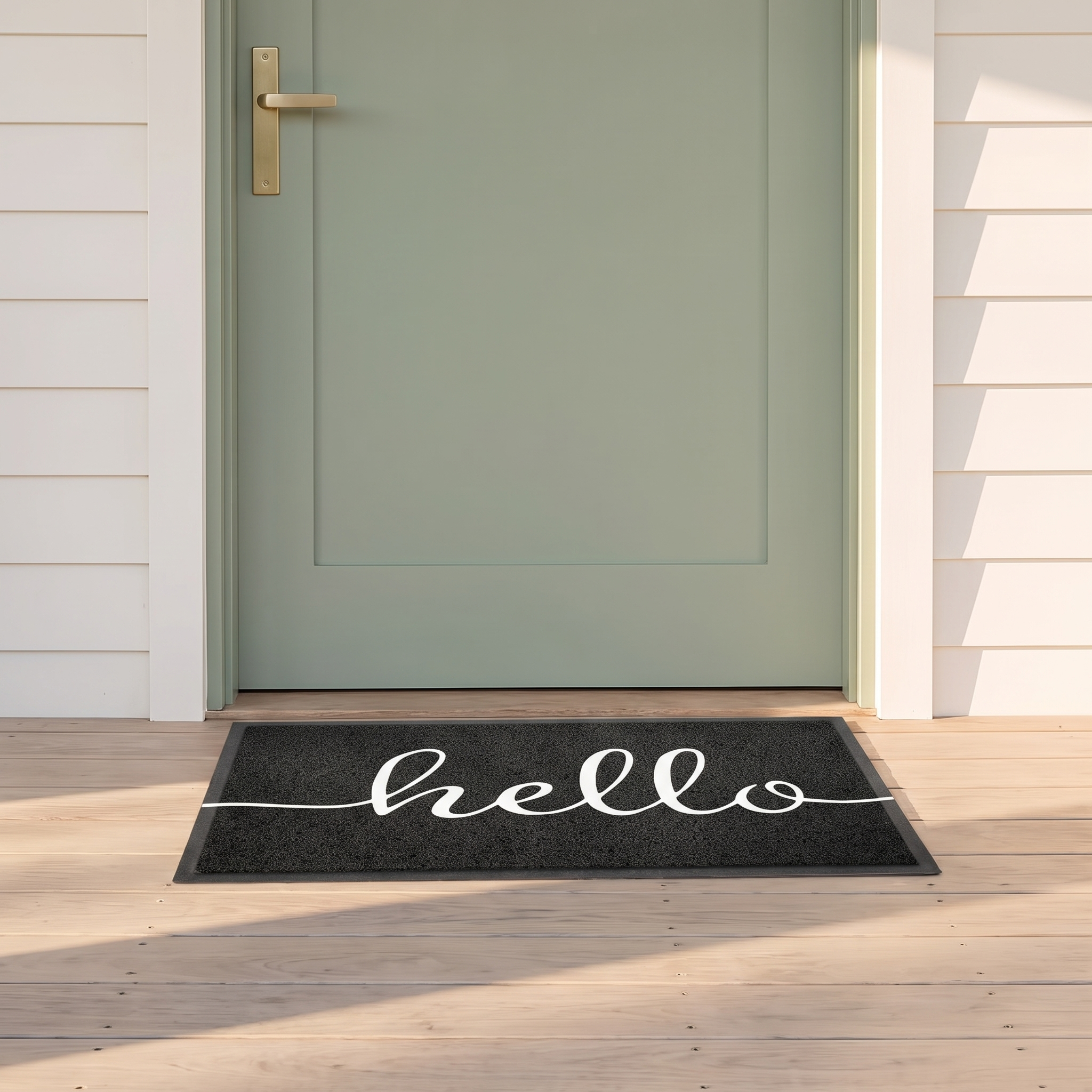 Hello welcome doormat in black on timber decking at a coastal beach house front door