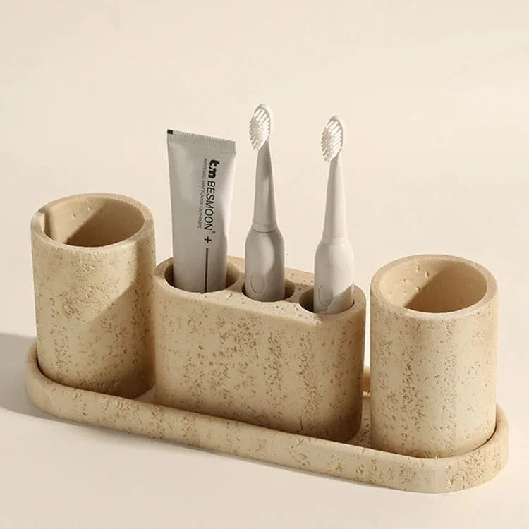Iven Sandstone rinse cup styled on a bathroom vanity