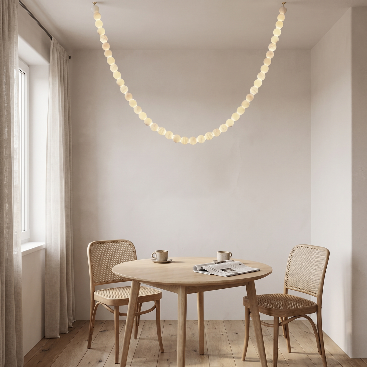Jawa alabaster bead pendant in the 16 light size as one modest swag over a breakfast nook table