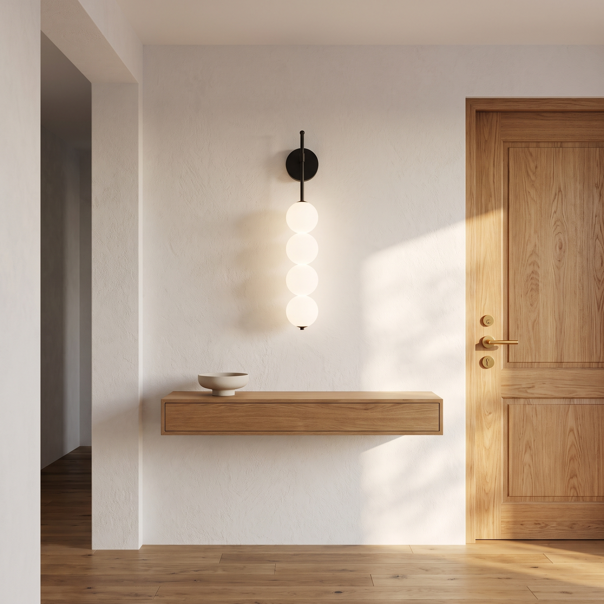Jilli opal glass wall sconce in black in an entryway near the front door