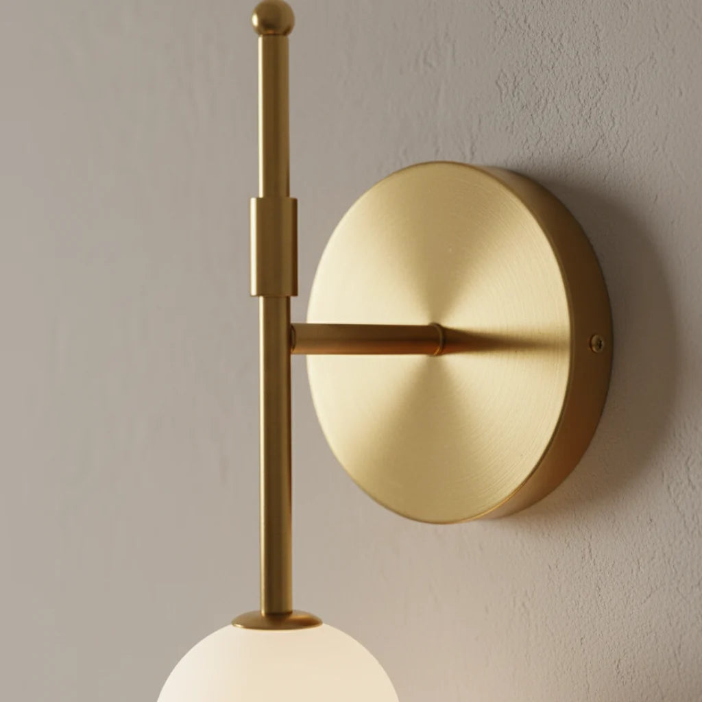 Jilli opal glass wall sconce close-up of the brushed gold wall plate and rod