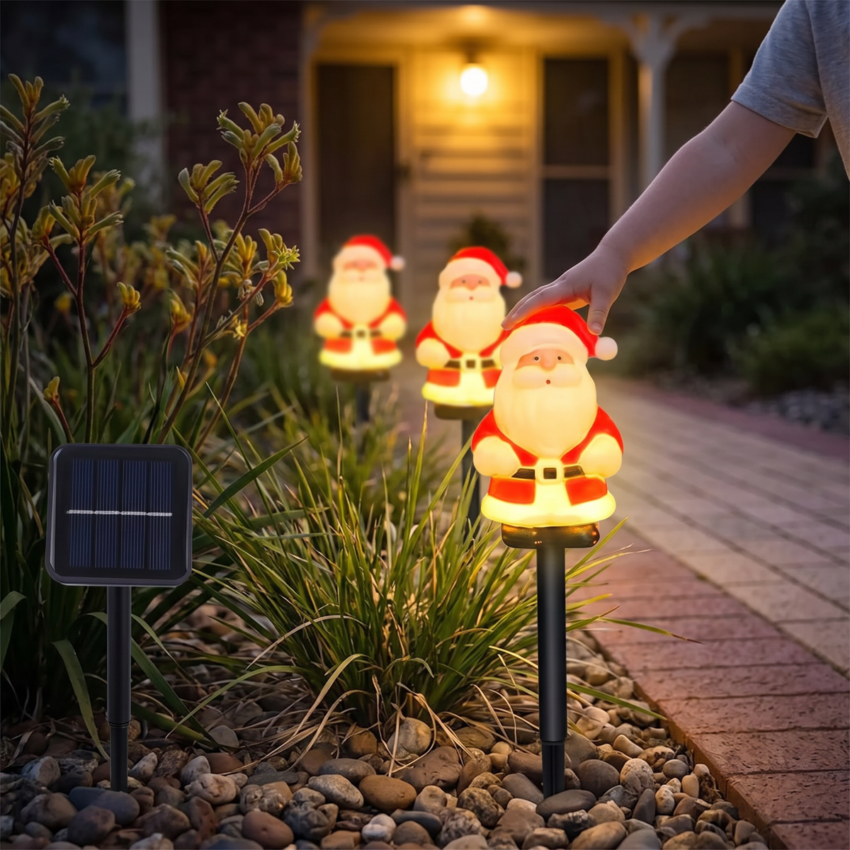 Close-up of a glowing Jolly solar Santa stake light with its solar panel