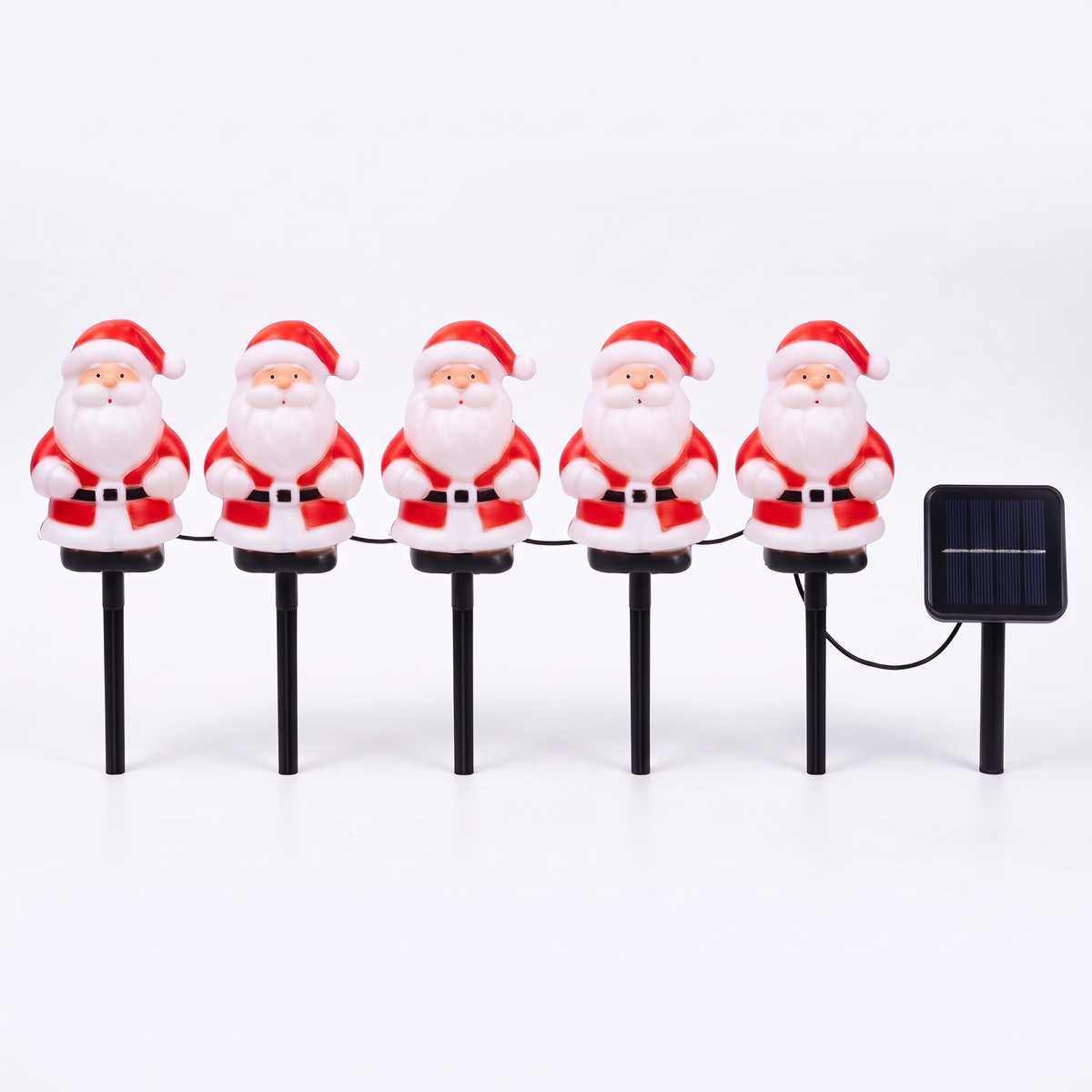 Set of five Jolly solar Santa stake lights and solar panel on a white background