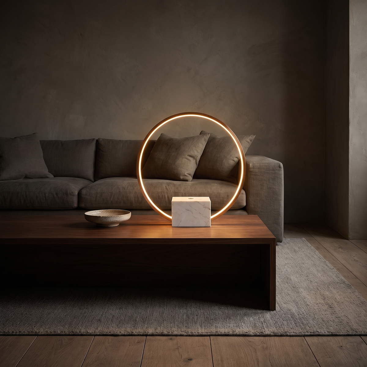 Juli marble table lamp with copper halo glowing on a walnut console in a living room