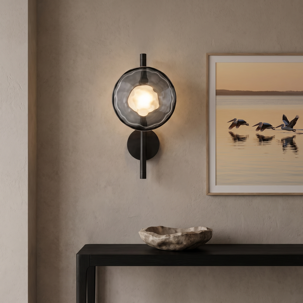 Kevi smoke grey ripple glass wall light on a black rod above a console in an entry