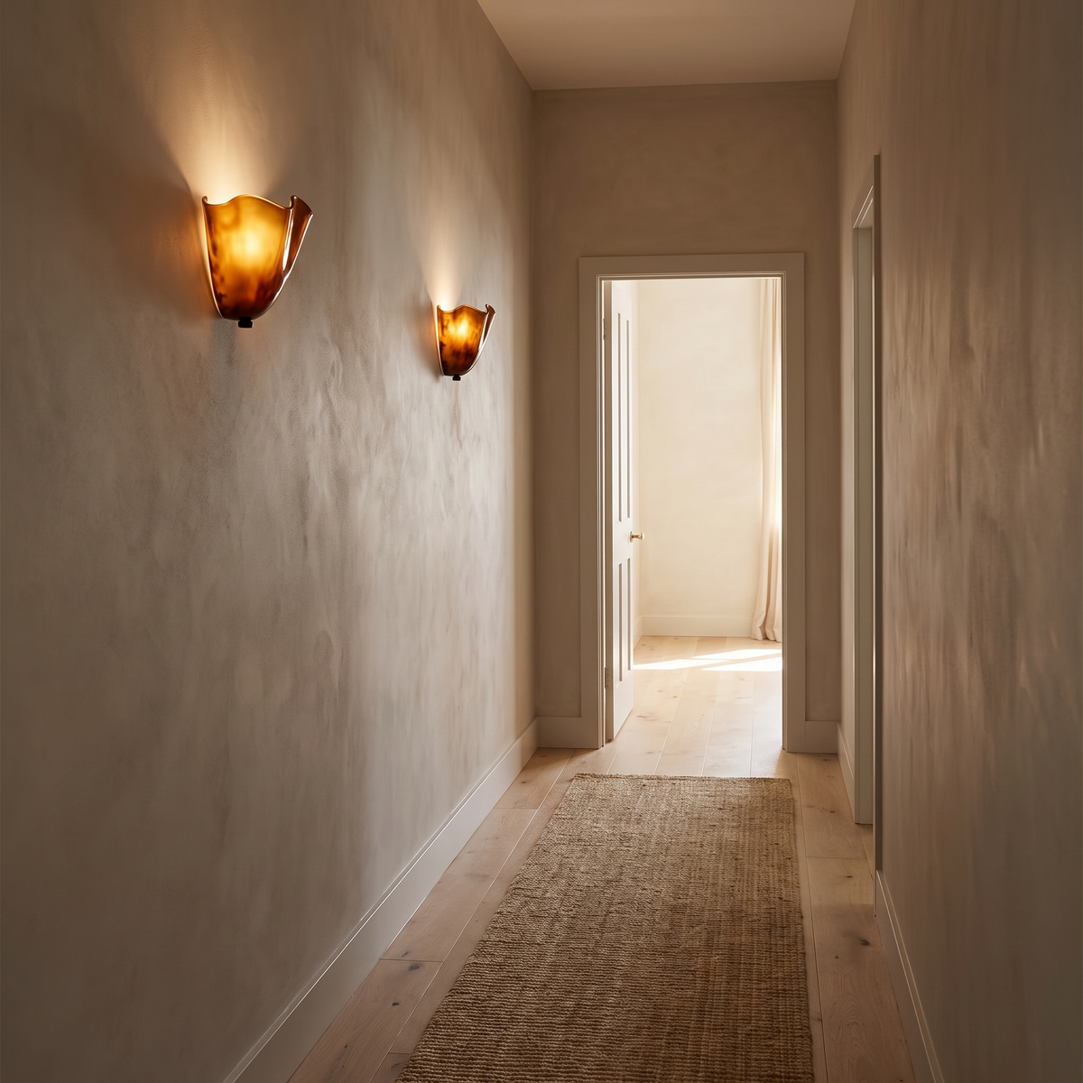 Two Kira artistic wall sconces in brown glass lit along a limewash hallway in an Australian home